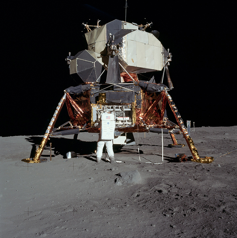 Photograph of Buzz Aldrin on the surface of the moon taken by astronaut Neil Armstrong. Aldrin is standing next to the Lunar Module and has his back to the camera.