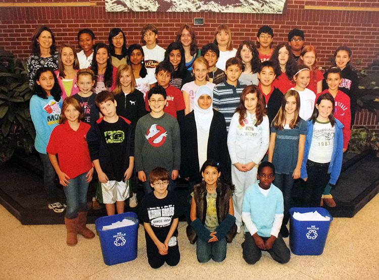 Yearbook photograph of students in Aldrin's recycling club taken during the 2009 to 2010 school year. The students are posed in the lobby on the stage outside the main office. 35 students and their teacher sponsor are pictured. 