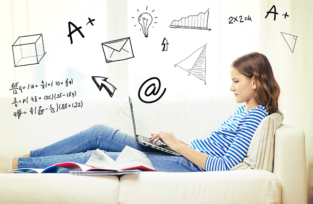 clipart of student studying at a computer with math symbols floating in the air.