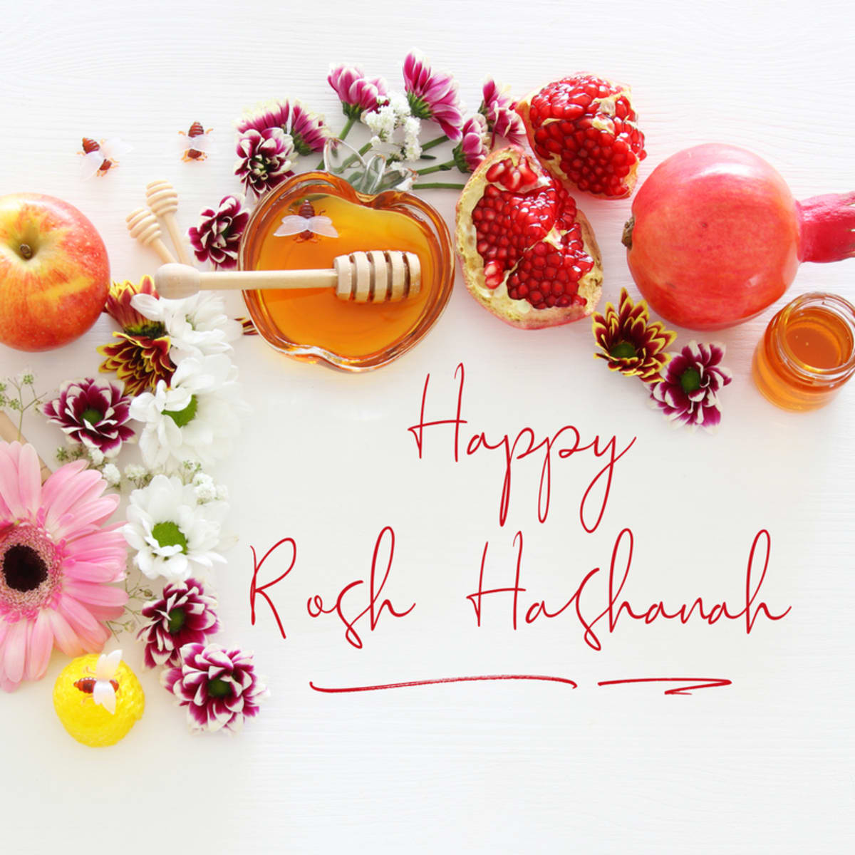 Happy Rosh Hashanah with holiday flowers and fruit.