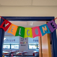 Welcome Banner of Different colors in the doorway of a classroom